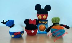 three crocheted mickey mouses and an orange