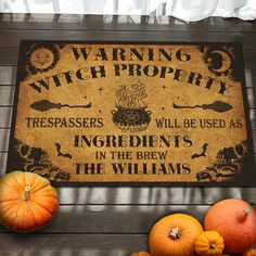 a sign that says warning witch property with pumpkins on the ground next to it