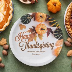 a plate with the words happy thanksgiving written on it surrounded by other plates and pumpkins