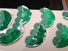 some paper plates with green leaves on them