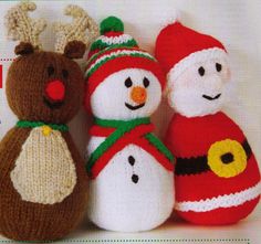 three knitted snowmen are standing next to each other