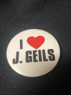 i love j geils button with heart on the back in black and white background