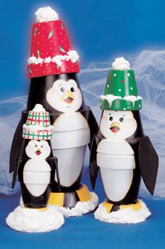 three penguins wearing christmas hats on top of each other