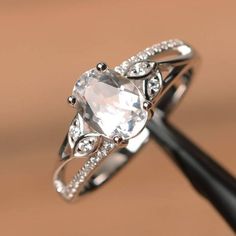 an engagement ring with a large white diamond in the center