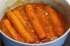 some carrots are cooking in a blue pot on the stove and it looks like they have been cooked