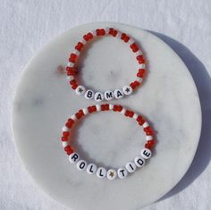 Show your school pride and complete your game day outfit with a custom crimson and white beaded bracelet for the University of Alabama! Red Custom Name Bracelet For Friendship, Adjustable Red Name Bracelet With Round Beads, School Spirit Letter Beads Bracelets Gift, Casual White Beaded Name Bracelet, School Spirit Beaded Bracelets With Letter Beads For Gifts, Adjustable Beaded Bracelets For Game Day With School Spirit, School Spirit Beaded Bracelet With Letter Beads As Gift, School Spirit Jewelry With Letter Beads For Gifts, Personalized School Spirit Jewelry For Game Day