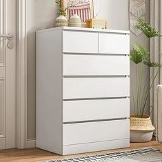 a white chest of drawers in a living room