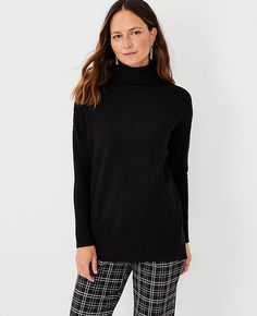 Elevate your wardrobe with the Ann Taylor Turtleneck Tunic Sweater, a chic and versatile addition perfect for any season. This elegant tunic features a cozy turtleneck, long sleeves with drop shoulders, and stylish side slits that enhance mobility without sacrificing style. The ribbed neck, cuffs, and hem add a touch of texture and refinement.

- Size: 2XS
- Color: Black
- Gender: Female
- Material: 41% Polyester, 37% Viscose, 22% Nylon
- Length: 28 inches long
- Care Instructions: Machine Washa Womens Black Sweater, Turtleneck Tunic Sweater, Turtleneck Tunic, Ann Taylor Petite, Knitted Suit, Fashion Jackson, Trendy Sweaters, Black Turtleneck, Fashion Today