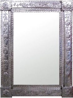 an ornate mirror is shown against a white background, with the reflection in it's frame