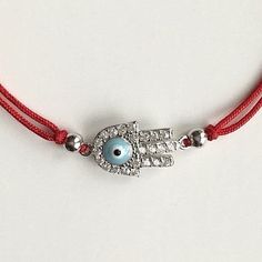 925 sterling silver hamsa evil eye red bracelet .adjustable .for protection ,good luck and prosperty. --comes with free gift pouche. pulsera rojo de plata esterlina 925 mano de fatima ojo de la buena suerte. ajustable. para proteccion ,buena suerte y prosperidad. --gratis bolsa de regalo. Traditional Jewelry Gift With Adjustable Length, Traditional Jewelry With Adjustable Length As Gift, Traditional Jewelry As A Gift With Adjustable Length, Traditional Resizable Jewelry For Gift, Adjustable Sterling Silver Evil Eye Bracelet, Spiritual Style, Adjustable Sterling Silver Evil Eye Bracelet, Adjustable Silver Evil Eye Bracelet Gift, Adjustable Sterling Silver Evil Eye Jewelry, Adjustable Evil Eye Jewelry Gift