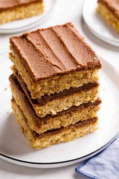 Stack of chewy peanut butter oatmeal bars topped with a layer of chocolate frosting, served on a white plate with a blue napkin. Lunch Lady Bars, Peanut Butter Oatmeal Cookie Bars, Oatmeal Cookie Bars, Cookie Base, Chunky Peanut Butter, Peanut Butter Oatmeal Cookies, Lunch Lady, Oatmeal Cookie, Peanut Butter Oatmeal