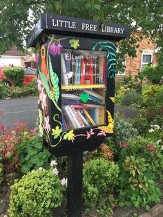 a little free library sign with books on it