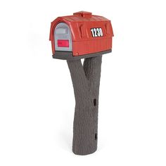 a red mailbox sitting on top of a wooden post in front of a white background