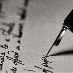 a fountain pen writing on top of a piece of paper with cursive writing