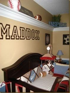 a baby's room with a baseball theme on the wall