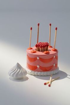 there is a cake with candles on it and some toothbrushes next to it