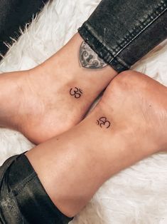 two people with matching tattoos on their feet