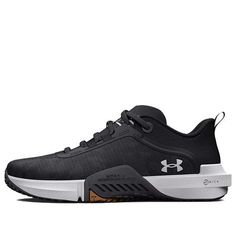 the under armour shoes are black and white