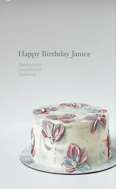 a birthday cake with pink flowers on it and the words happy birthday janie written in white