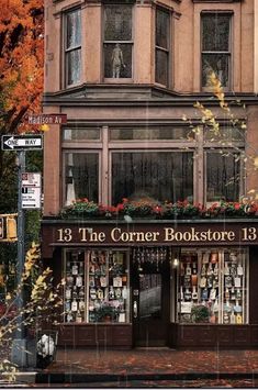 the corner bookstore 13 is located in an old building with many windows and flower boxes