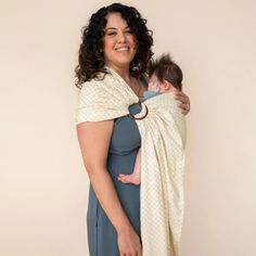 a woman holding a baby wrapped in a blanket