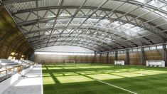 an indoor soccer field with grass and benches on the sidelines is shown in this artist's rendering