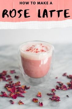 rose latte in a glass cup with pink flowers around it and the title how to make a rose latte