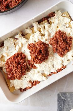 a casserole dish with meatballs and cheese on top, ready to be eaten