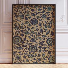 an ornate wallpaper with blue flowers and leaves on it in front of a wooden floor