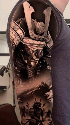 a man with a tattoo on his arm holding a skateboard