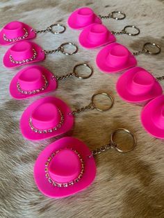 a bunch of pink items are laying on a fur surface with chains attached to them