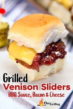 grilled venison sliders with bbq sauce, bacon and cheese on a white plate