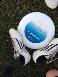 two shoes and a frisbee laying on the grass