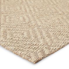 the textured rug is beige and has a small diamond pattern on top of it