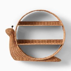 a wicker shelf with a snail on it's back and two shelves in the middle