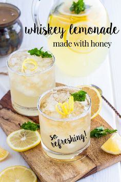 two glasses filled with lemonade sitting on top of a cutting board