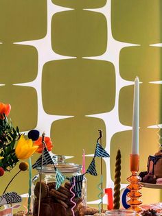 a table topped with lots of cakes and candles