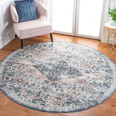 a round rug in a living room with a chair