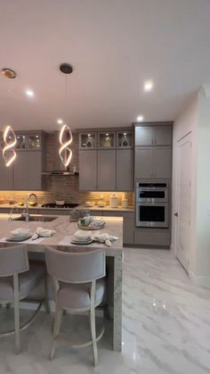 a large kitchen with marble floors and gray cabinets