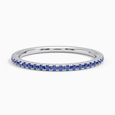 a white gold band with blue sapphire stones