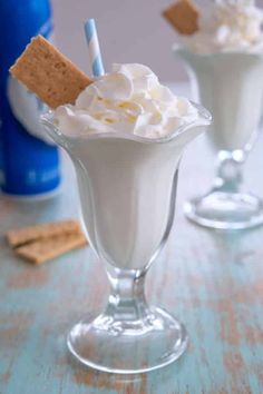 two glasses filled with whipped cream and graham crackers