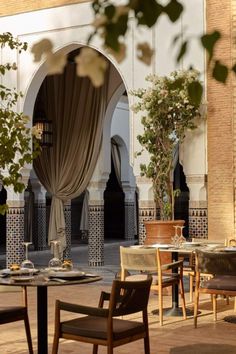 an outdoor dining area with tables and chairs