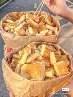 two baskets filled with food sitting on the side of a road next to each other