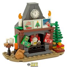 there is a lego christmas fireplace with decorations on the mantle and around it's clock