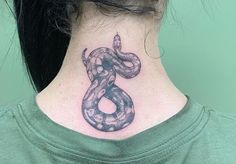 a woman with a snake tattoo on her neck