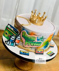 there is a cake that has been decorated with stickers and a crown on top