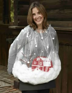 a woman wearing a plastic bag with a red house on it and white fur around her shoulders