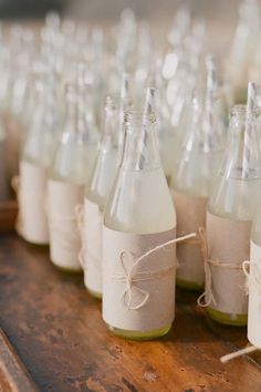 several empty bottles tied with twine on a wooden table