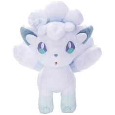 a white stuffed animal with blue eyes and wings on it's head, sitting in front of a white background