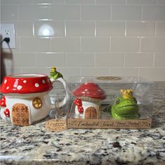 two ceramic figurines sitting on top of a counter